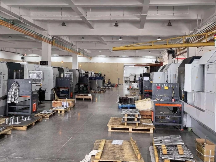 Expansive factory floor with overhead cranes and organized workstations