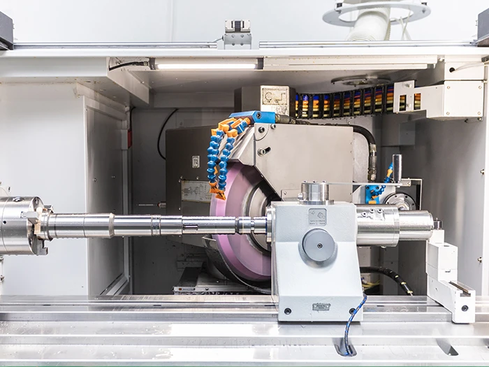 Cylindrical grinding machine finishing a precision workpiece