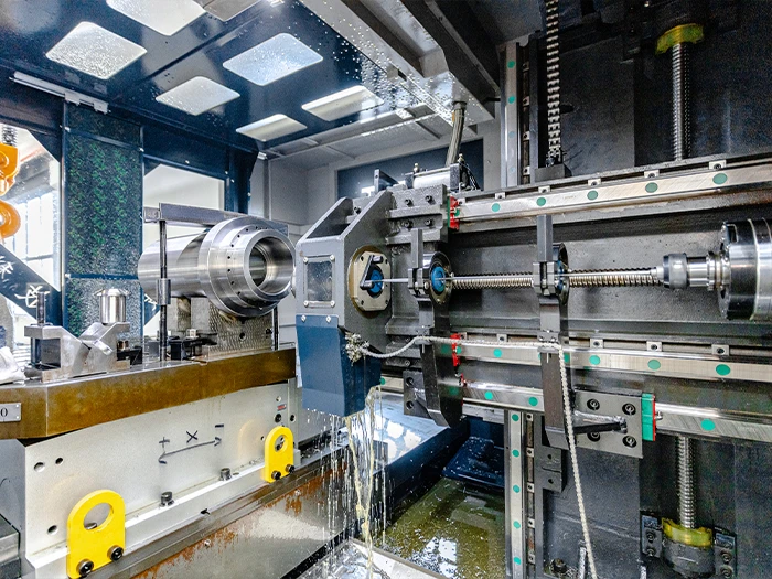 CNC lathe processing metal shaft with coolant spray