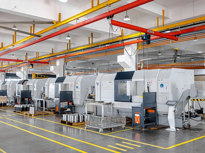 Row of CNC machining centers numbered 03 through 16 on the production floor